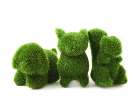 Toy animal statuettes made of plastic green grass as an Easter decoration, composition isolated over the white backgroundの写真素材