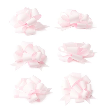 Decorational rose pink ribbon gift bow isolated over the white background, set collection of six diffirent foreshorteningsの写真素材