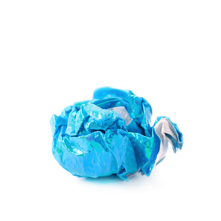 Crumbled ball of colorful origami paper sheet isolated over the white backgroundの写真素材