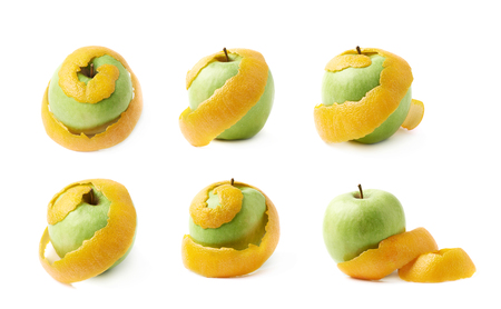 Green apple covered with orange peel, composition isolated over the white background, set of six different foreshorteningsの写真素材