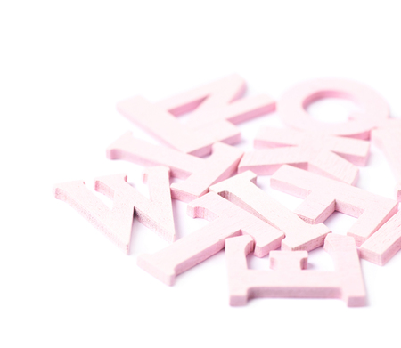 Pile of colorful paint coated wooden letters isolated over the white backgroundの写真素材