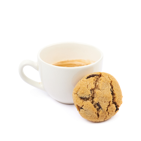 Single soft chewy chocolate chip cookie next to a cup of coffee, composition isolated over the white backgroundの写真素材