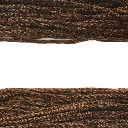Embroidery thread yarn as a borders of a copyspace composition isolated over the white background