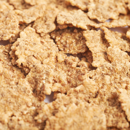 Surface coated with the wholegrain cereal flakes as a texture backdrop compositionの写真素材