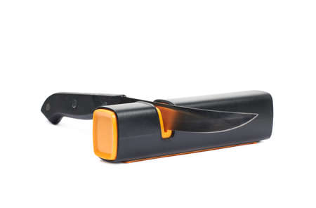 Knife in a plastic black sharpener tool, composition isolated over the white backgroundの写真素材