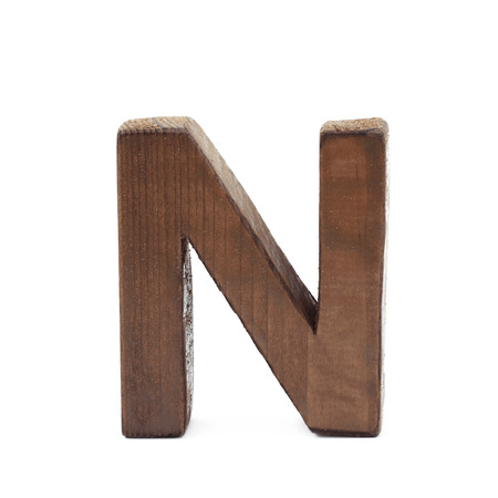 Single sawn wooden letter N symbol coated with paint isolated over the white backgroundの写真素材