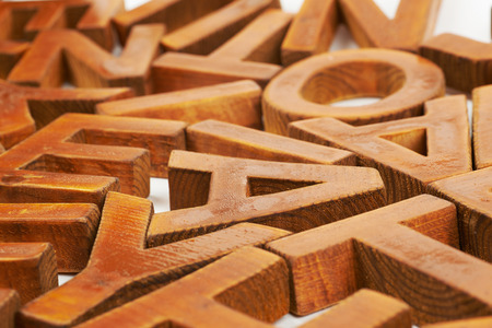 Surface coated with the multiple painted wooden block letters as an abstract backrop compositionの写真素材
