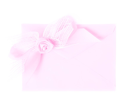 Paper envelope decorated with the bow isolated over the white backgroundの写真素材