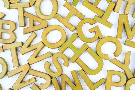 Surface coated with the multiple painted wooden block letters as an abstract backrop compositionの写真素材