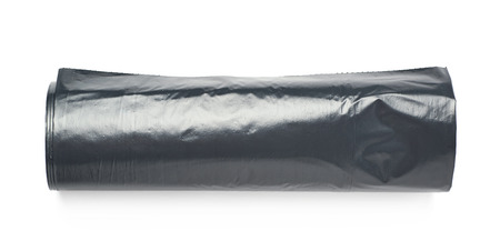Black plastic polyethylene trash bag roll isolated over the white backgroundの写真素材
