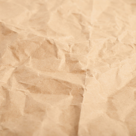 Crumbled paper sheet as a backdrop background composition textureの写真素材