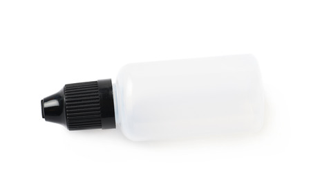 Plasic 30 ml bottle lying on its side, isolated over the white background