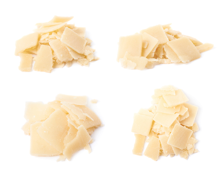 Pile of parmesan cheese flakes isolated over the white background, set of four different foreshorteningsの写真素材