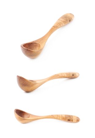 Wooden serving spoon isolated over the white background, set of three different foreshorteningsの写真素材