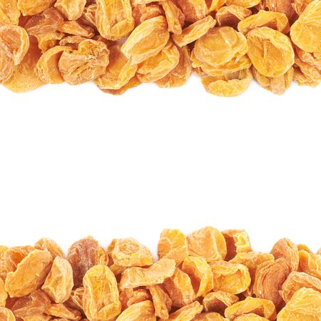 Copyspace backdrop composition with the borders made of dried apricot fruits isolated over the white backgroundの写真素材