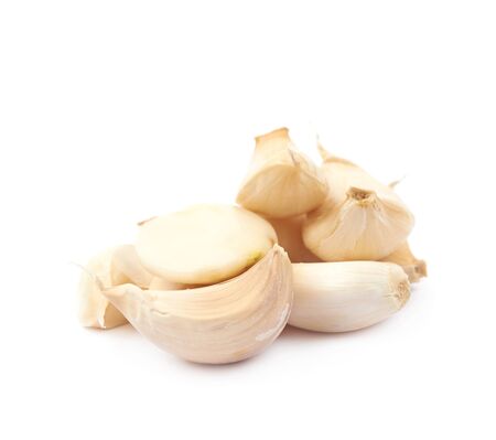 Pile of garlic cloves isolated over the white background