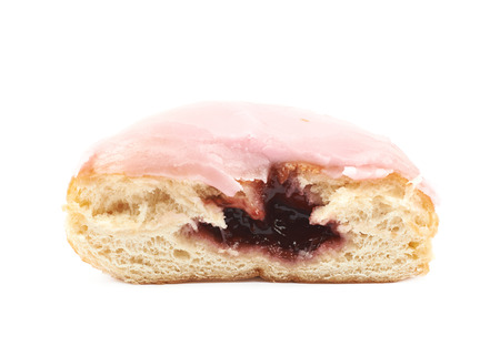 Half of a pink glazed donut isolated over the white backgroundの写真素材
