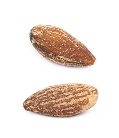 Almond nut coated with spicy powder isolated over the white background, set of two different foreshorteningsの写真素材