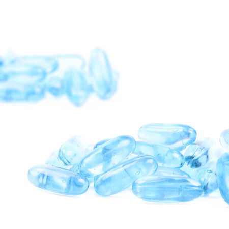 Pile of blue softgel pills isolatedの写真素材