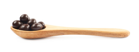 Wooden spoon full of candiesの写真素材