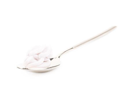 Spoon filled with frosting cream isolatedの写真素材