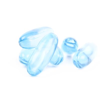 Pile of blue softgel pills isolatedの写真素材