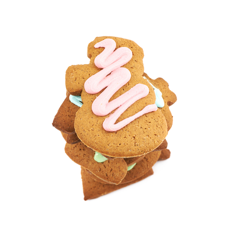 Pile of glazed gingerbread cookies isolated over the white background