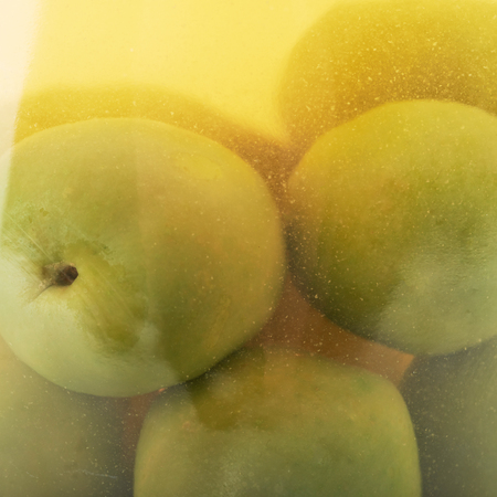 Close-up fragment of a glass jar full of the green olivesの写真素材