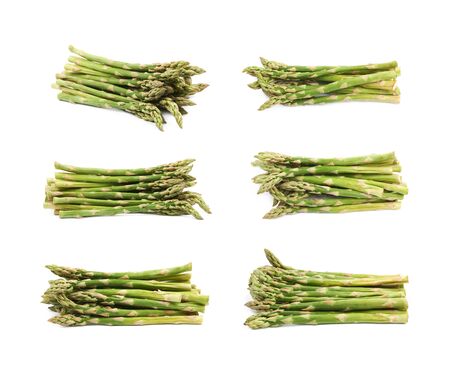 Pile of multiple cultivated green asparagus spears isolated over the white background, set of six different foreshorteningsの写真素材
