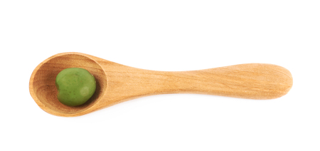 Single olive in a wooden spoonの写真素材