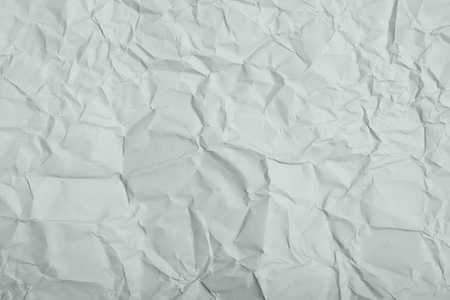 Close-up fragment of a gray crumpled paper texture as a backdrop compositionの写真素材