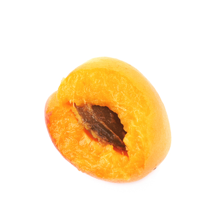 Single yellow plum fruit with a bite taken of it, composition isolated over the white backgroundの写真素材