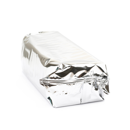 Product packed in a silver foil package isolated over the white backgroundの写真素材