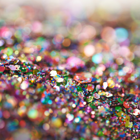 Abstract colorful background composition made of pile of tinsel shot in bokeh as a backdropの写真素材
