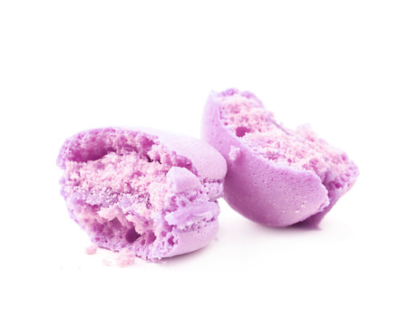 Crumbled bitten macaron cookie isolated over the white backgroundの写真素材