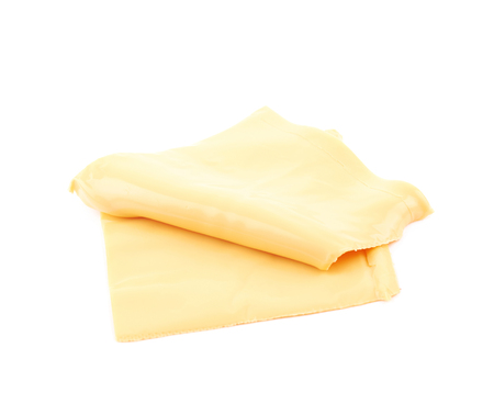 Slice of processed cheese isolated over the white backgroundの写真素材