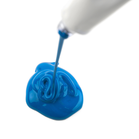 Paint spilling out of a dye tube isolated over the white backgroundの写真素材