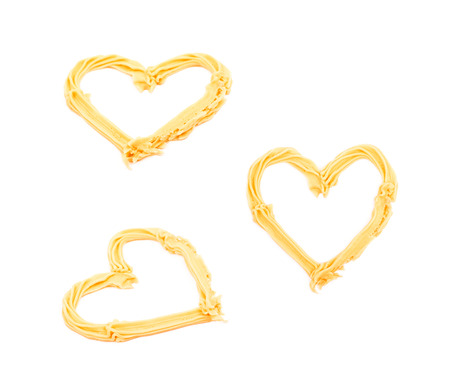 Heart shape made of frosting cream isolated over the white background, set of three different foreshorteningsの写真素材