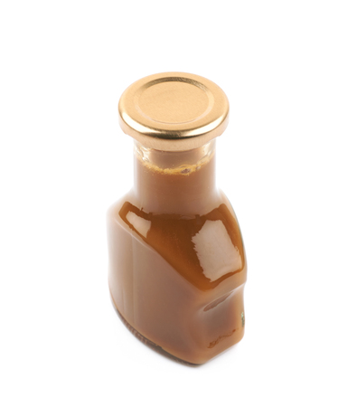 Bottle of caramel sauce isolated over the white backgroundの写真素材