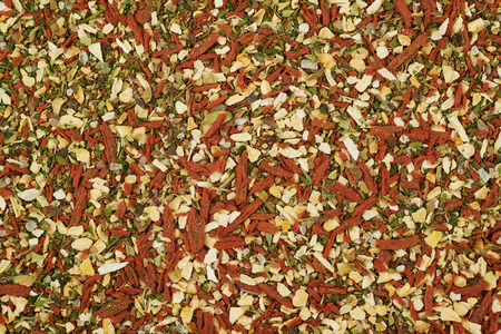 Surface coated with italian spices, close-up crop fragment as a backdrop texture compositionの写真素材