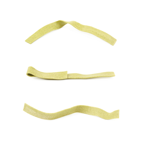 Single piece of green fettucce pasta isolated over the white background, set of three different foreshorteningsの写真素材