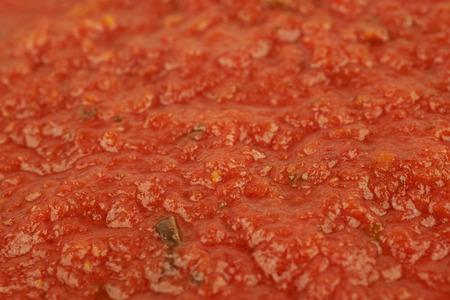 Surface coated with marinara tomato sauce as a backdrop composition texture with the shallow depth of fieldの写真素材