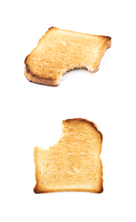 Toasted white bread with the bite taken of it, composition isolated over the white background, set of two different compositionsの写真素材