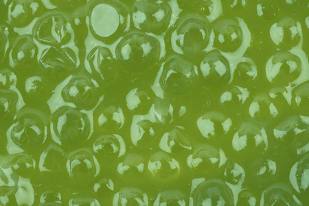 Surface coated with the green caviar as a close-up backdrop texture compositionの写真素材