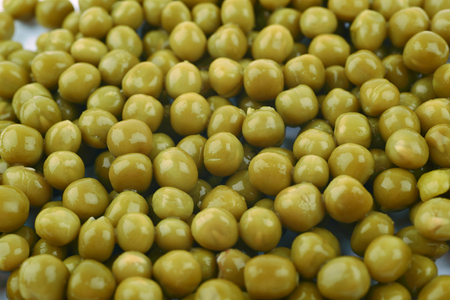 Surface covered with the green peas as a close-up backdrop compositionの写真素材