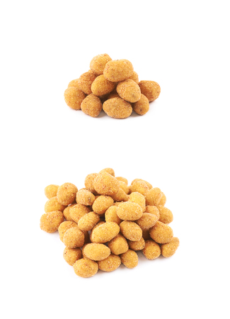 Pile of breadcrumb coated spiced nuts isolated over the white background, set of two different foreshorteningsの写真素材