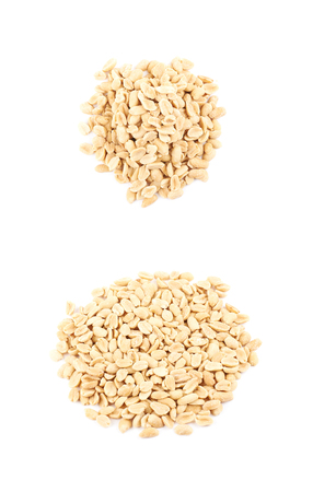Pile of salted peanuts isolated over the white background, set of two different foreshorteningsの写真素材