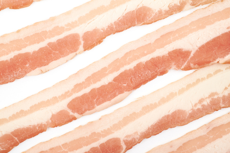 Surface coated with raw bacon slicesの写真素材
