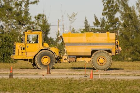 A water truck  sits idle while the operator is in a meeting