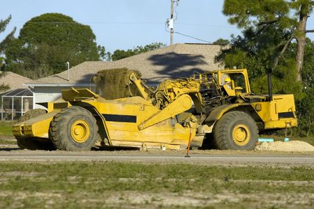 A road scrapper at work filling it's bed